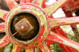 Ancient wooden wheel of an old wagon photo