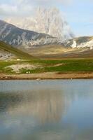 a small lake with rocks and water photo