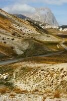 a road winding through a mountain range photo