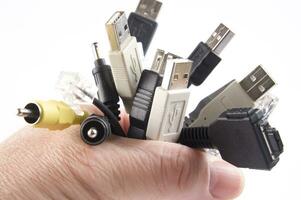 a hand holding several different types of cables photo