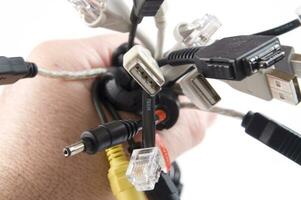 a hand holding several different types of cables photo