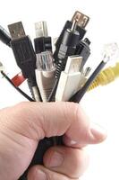 a hand holding several different types of cables photo