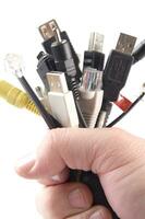 a hand holding several different types of cables photo