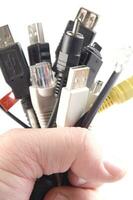a hand holding several different types of cables photo