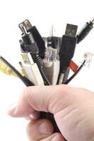 a hand holding several different types of cables photo