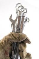 a pair of gloves with a wrench and a pair of pliers photo