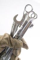 a pair of gloves with a wrench and a pair of pliers photo