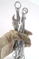 a pair of gloves with a wrench and a pair of pliers photo