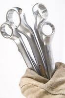 a pair of gloves with a wrench and a pair of pliers photo