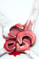 three wrenches with red liquid on them photo