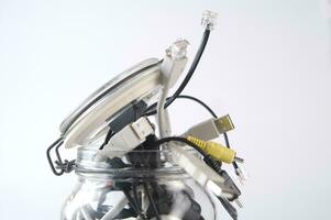 a glass jar filled with wires photo