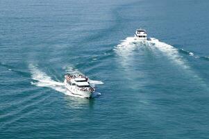 two boats traveling in the ocean photo