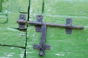 a close up of a green door with a latch photo