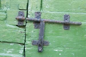 a close up of a green door with a latch photo