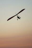 a hang glider is flying in the air photo