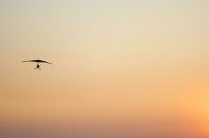 a hang glider is flying in the air photo