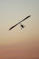 a hang glider is flying in the air photo