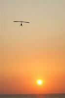 a hang glider is flying in the air photo