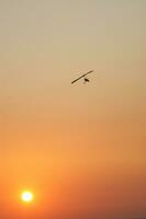 a hang glider is flying in the air photo