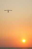 a hang glider is flying in the air photo