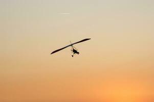 a hang glider is flying in the air photo