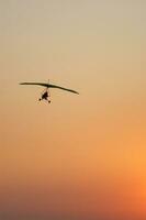 a hang glider is flying in the air photo