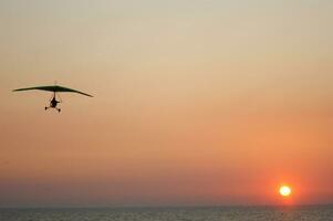 a hang glider is flying in the air photo