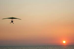 a hang glider is flying in the air photo