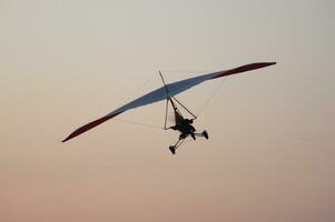 a hang glider is flying in the air photo