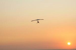 a hang glider is flying in the air photo
