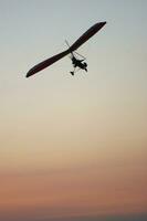 a hang glider is flying in the air photo