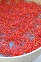 a pile of red saffron on a plate photo