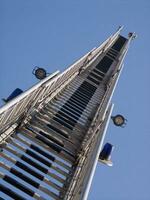 a tall metal tower with a blue sky in the background photo