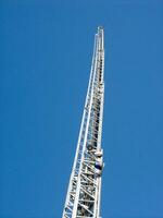 a tall metal tower with a blue sky in the background photo