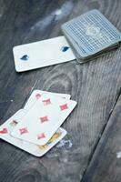 a person is playing cards with a deck of cards photo