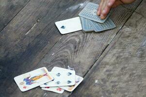 a person is playing cards with a deck of cards photo