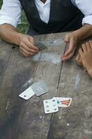 a person is playing cards with a deck of cards photo