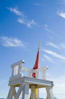 a lifeguard chair sitting on a beach photo