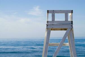 a lifeguard chair sitting on a beach photo