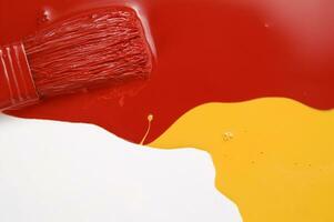 a red, yellow and white liquid is being poured photo