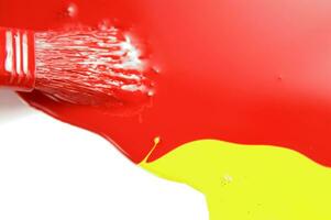 a red, yellow and white liquid is being poured photo