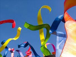 a group of colorful kites flying in the sky photo