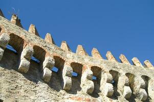 a stone wall with a clock on it photo