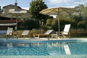 a blue pool with a white umbrella photo