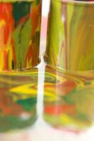 a close up of two tubes with paint on them photo