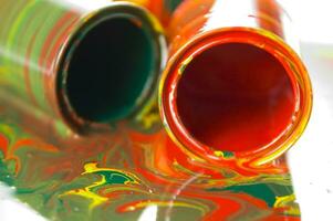 a close up of two tubes with paint on them photo