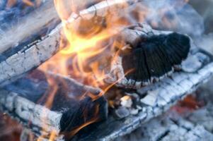 a close up of a fire with wood and coal photo