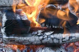 a close up of a fire with wood and coal photo