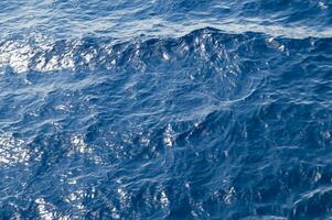 an aerial view of the ocean with a boat in the water photo