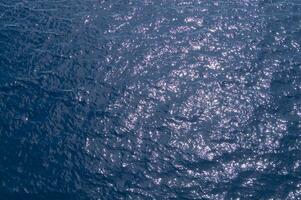 an aerial view of the ocean with a boat in the water photo